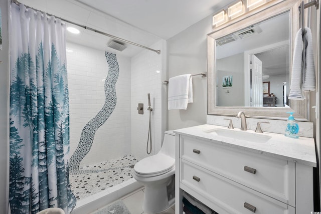 bathroom with a shower with curtain, tile patterned floors, vanity, and toilet