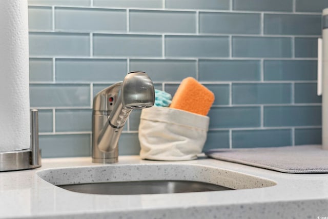 room details featuring sink and light stone counters