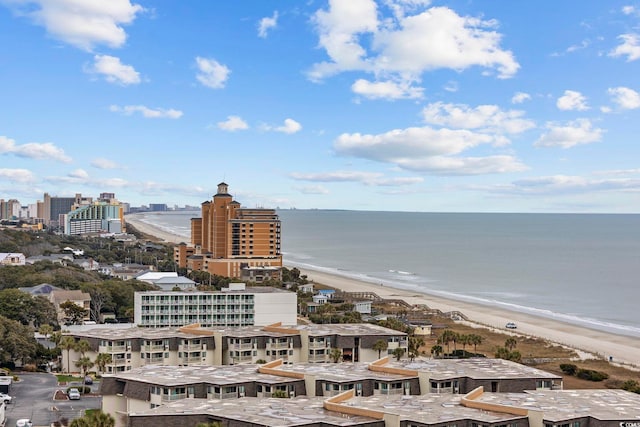 birds eye view of property with a water view and a view of the beach