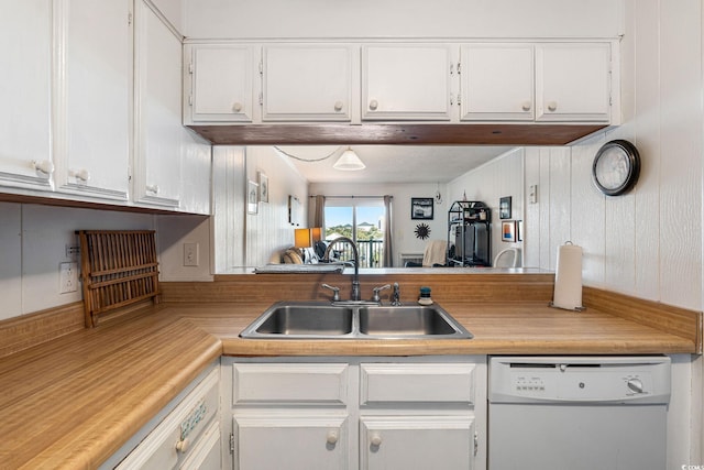 kitchen with sink, white cabinetry, and dishwasher