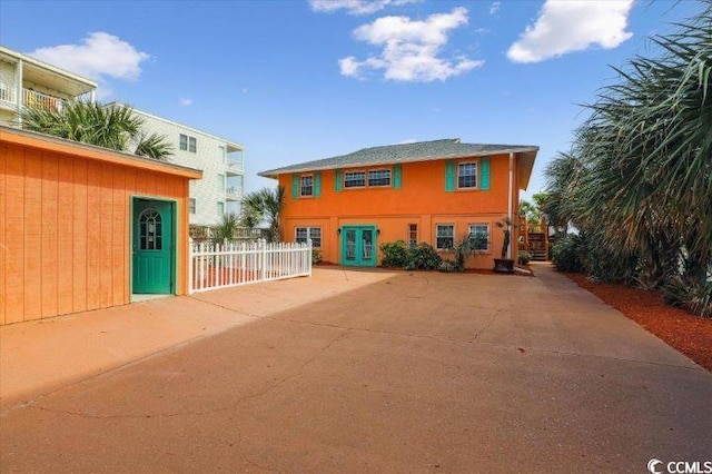 view of front of home with french doors and a patio area