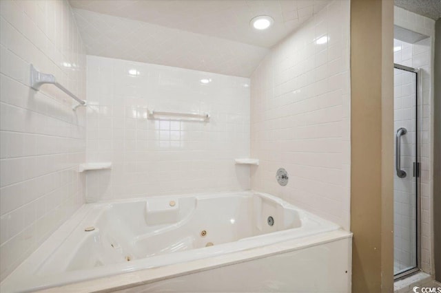 bathroom featuring lofted ceiling and independent shower and bath