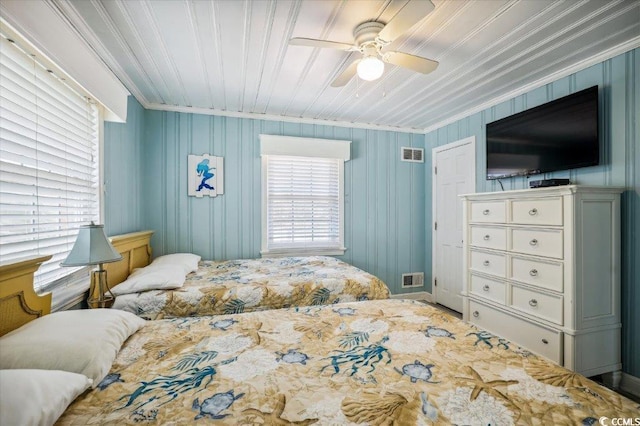 bedroom with ornamental molding and ceiling fan