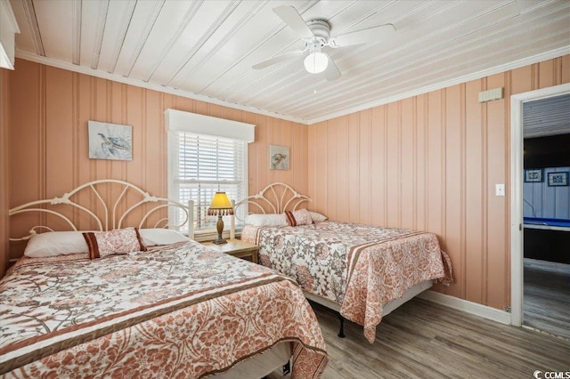 bedroom with ornamental molding, ceiling fan, hardwood / wood-style flooring, and wood ceiling