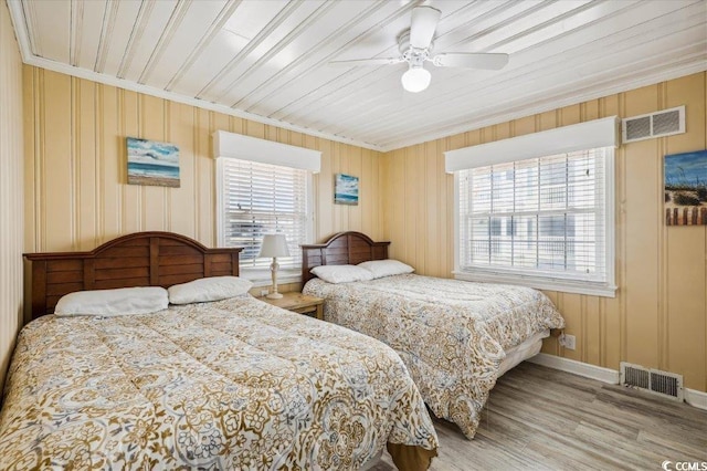 bedroom featuring ceiling fan, wood ceiling, light hardwood / wood-style floors, and crown molding