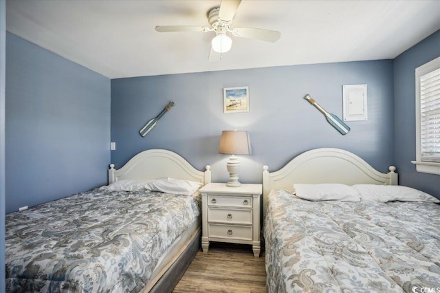 bedroom featuring ceiling fan and dark wood-type flooring