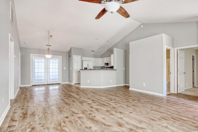 unfurnished living room with ceiling fan, light wood-type flooring, and high vaulted ceiling