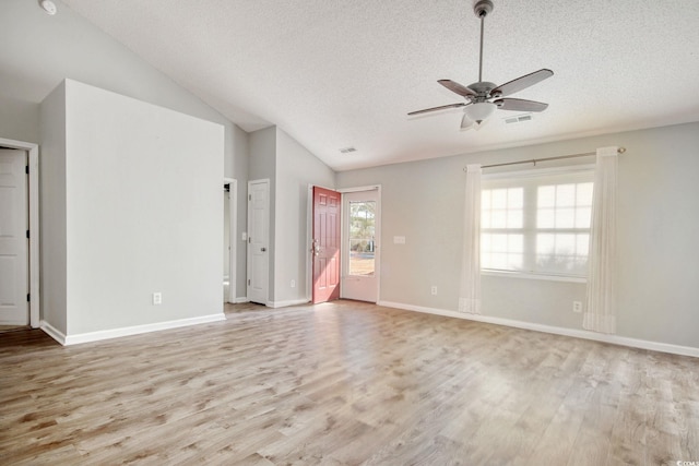 unfurnished room with vaulted ceiling, ceiling fan, a textured ceiling, and light hardwood / wood-style flooring