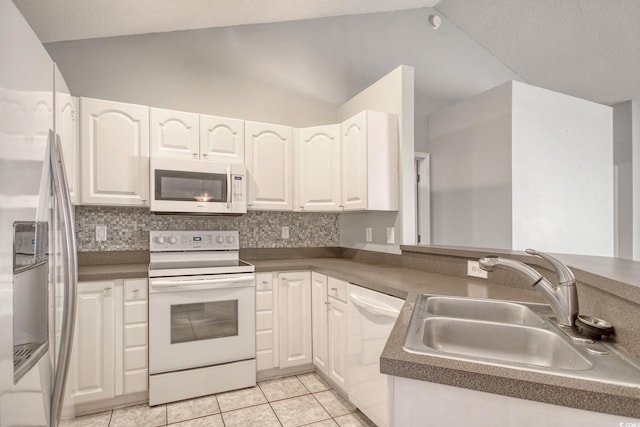 kitchen featuring vaulted ceiling, sink, white appliances, and white cabinetry