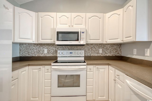 kitchen featuring decorative backsplash, white appliances, and white cabinets