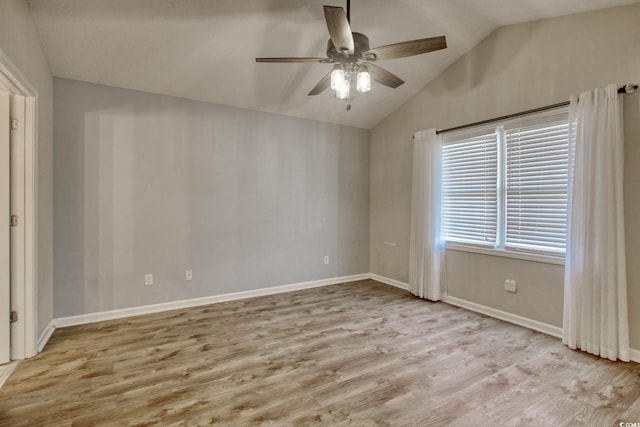 empty room with vaulted ceiling, ceiling fan, and light hardwood / wood-style flooring