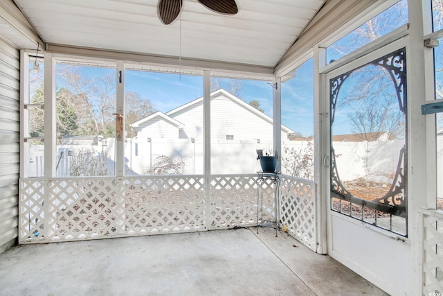 unfurnished sunroom featuring ceiling fan and vaulted ceiling