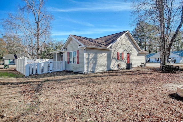 view of side of home with central AC