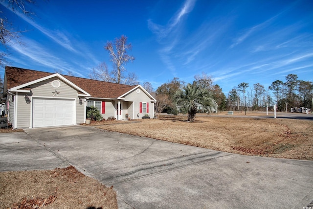 ranch-style house with a garage and a front lawn