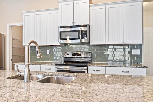 kitchen featuring sink, white cabinets, and stainless steel appliances