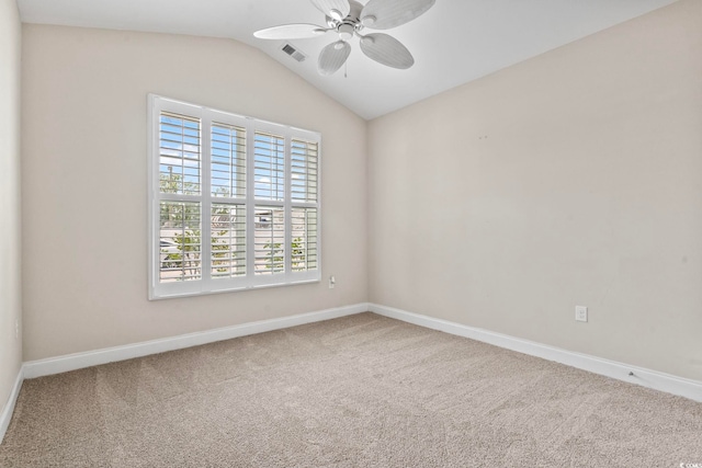 carpeted spare room with ceiling fan and lofted ceiling