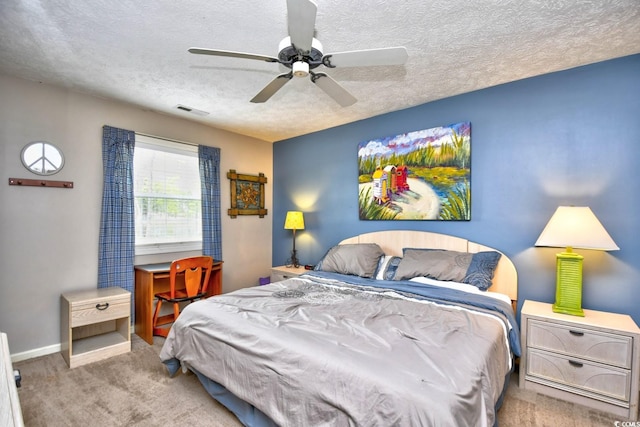 carpeted bedroom with visible vents, ceiling fan, a textured ceiling, and baseboards