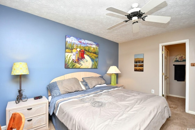 bedroom featuring a textured ceiling, carpet floors, ceiling fan, and baseboards