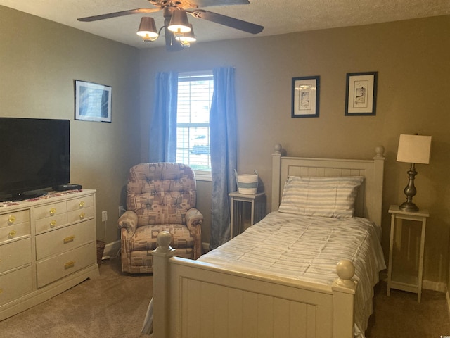 bedroom with carpet, a textured ceiling, and a ceiling fan