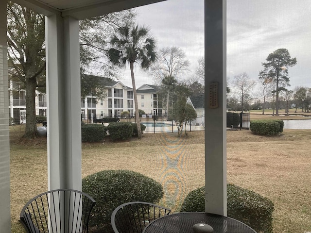 view of community with a pool and fence