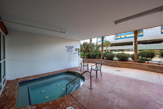 view of pool with an indoor in ground hot tub and a patio