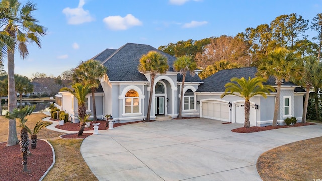 view of front facade featuring a garage and a water view