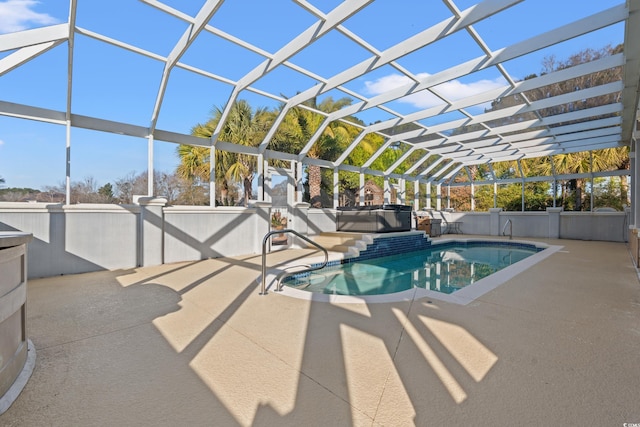 view of swimming pool featuring a lanai and a patio