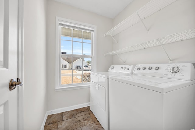 washroom featuring light tile patterned floors and washing machine and clothes dryer