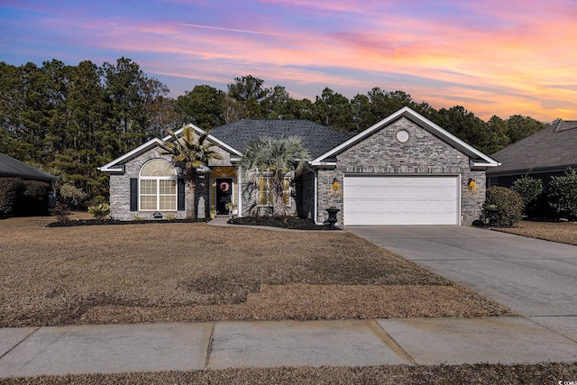 ranch-style house with a yard and a garage