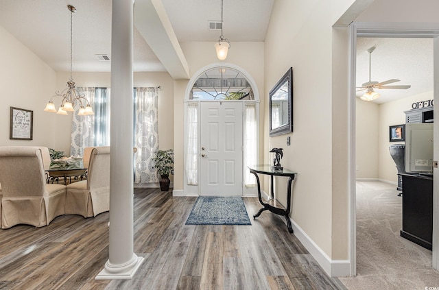 entrance foyer featuring ceiling fan with notable chandelier, hardwood / wood-style floors, and a textured ceiling