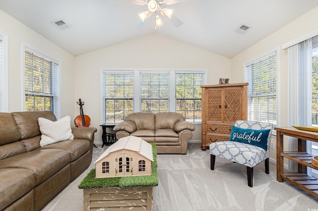 carpeted living room with ceiling fan and lofted ceiling