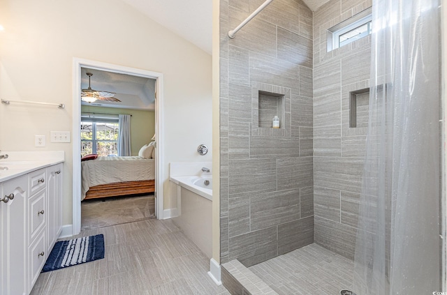 bathroom with ceiling fan, a tile shower, tile patterned floors, and vanity