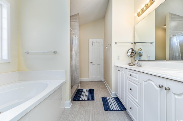 bathroom with vanity, lofted ceiling, and shower with separate bathtub