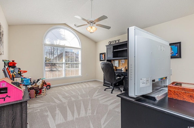 carpeted office with ceiling fan, plenty of natural light, and lofted ceiling