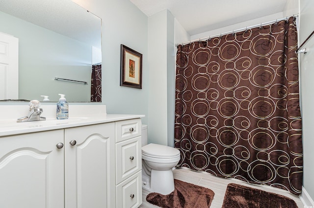 bathroom with toilet, vanity, and a textured ceiling