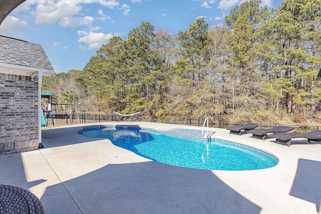 view of pool with a playground and a patio