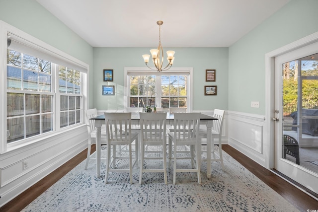 dining area featuring a chandelier, dark hardwood / wood-style flooring, and plenty of natural light