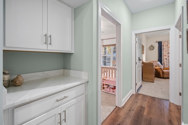 corridor with light hardwood / wood-style floors