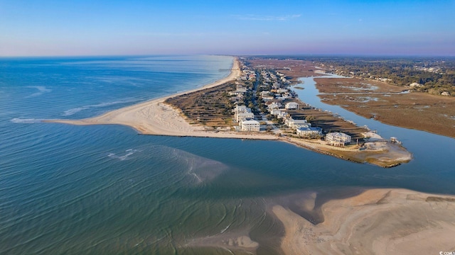 aerial view at dusk featuring a beach view and a water view