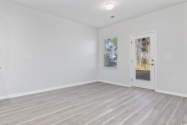 spare room with hardwood / wood-style floors