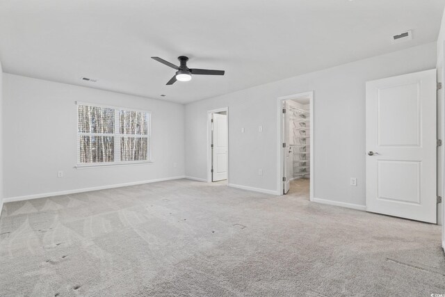 spare room with light colored carpet and ceiling fan