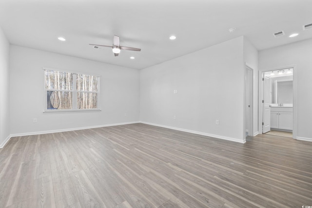 spare room featuring ceiling fan and light hardwood / wood-style flooring