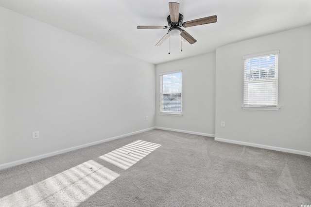 carpeted empty room with ceiling fan and a healthy amount of sunlight