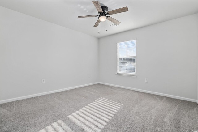 carpeted spare room with a chandelier