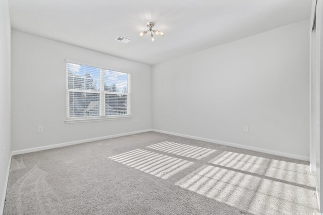 spare room featuring carpet and ceiling fan