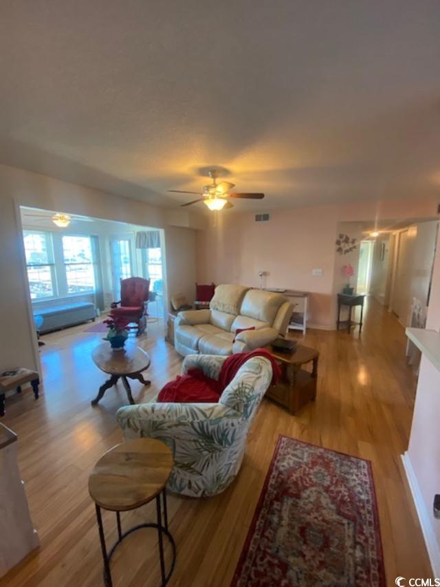 8650 Southbridge Dr Unit A, Surfside Beach, SC 29575 - living room with light wood finished floors and a ceiling fan