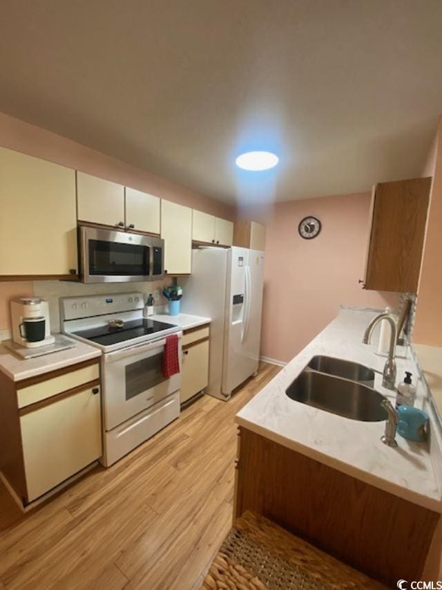 8650 Southbridge Dr Unit A, Surfside Beach, SC 29575 - kitchen with white appliances, light wood-type flooring, light countertops, and white cabinets