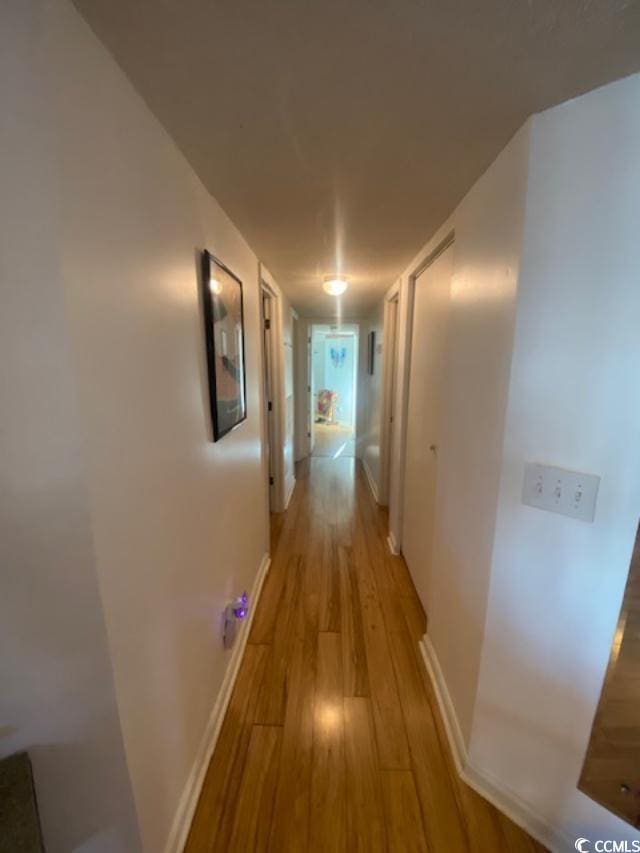 8650 Southbridge Dr Unit A, Surfside Beach, SC 29575 - hallway featuring light wood-type flooring and baseboards