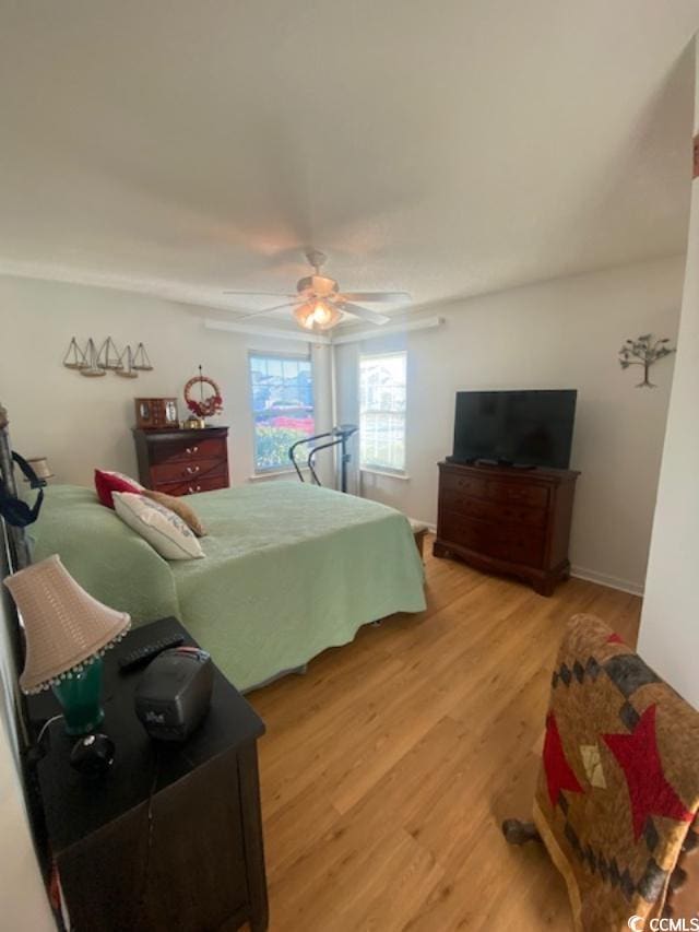 8650 Southbridge Dr Unit A, Surfside Beach, SC 29575 - bedroom with light wood finished floors and ceiling fan