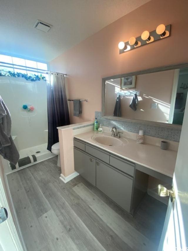8650 Southbridge Dr Unit A, Surfside Beach, SC 29575 - full bath featuring wood finished floors, a stall shower, and vanity